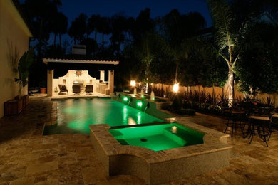 Design ideas for a large mediterranean backyard rectangular lap pool in San Diego with a water feature and tile.