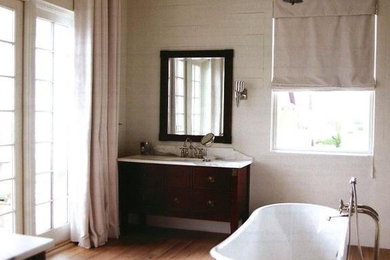 Inspiration for a large timeless master light wood floor freestanding bathtub remodel in Wilmington with shaker cabinets, dark wood cabinets, white walls, an undermount sink and marble countertops