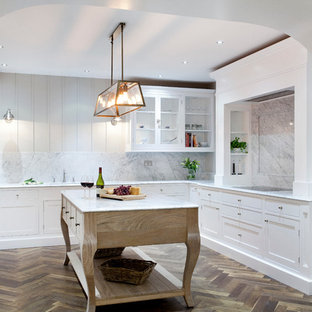 Large eclectic kitchen pantry inspiration - Inspiration for a large eclectic u-shaped dark wood floor kitchen pantry remodel in Dublin with a single-bowl sink, beaded inset cabinets, white cabinets, marble countertops, white backsplash, stone slab backsplash, stainless steel appliances and an island