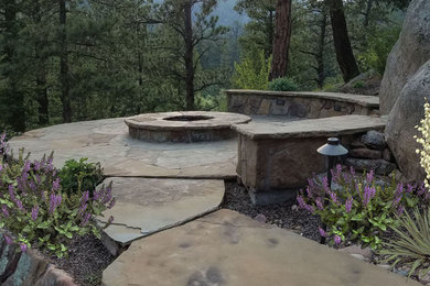 Design ideas for a large traditional drought-tolerant and partial sun backyard stone landscaping in Denver with a fire pit for spring.