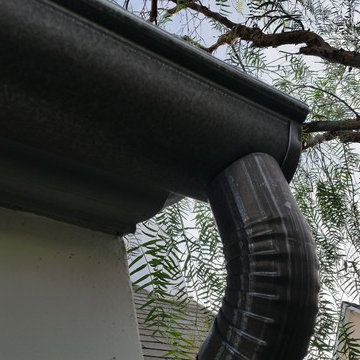 Bonderized Steel, 5 inch Half Round Seamless Gutters with Round Downspouts.