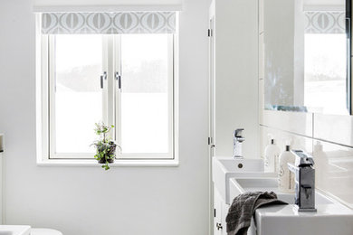 Inspiration for a mid-sized scandinavian master wet room bathroom in Copenhagen with beaded inset cabinets, white cabinets, an undermount tub, a wall-mount toilet, beige tile, ceramic tile, white walls, ceramic floors and beige floor.