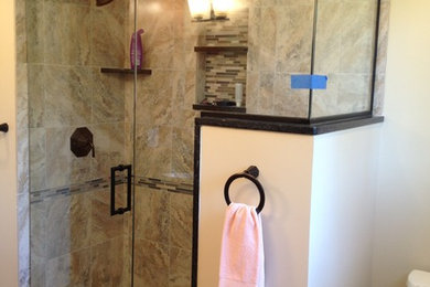 Mid-sized elegant beige tile and stone tile porcelain tile corner shower photo in Cleveland with an undermount sink, shaker cabinets, granite countertops, a one-piece toilet and beige walls