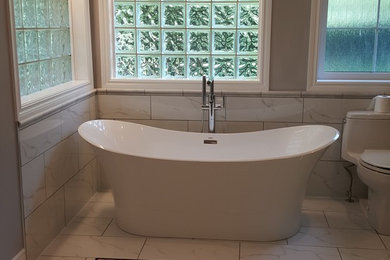 Example of a mid-sized transitional bathroom design in Other with a two-piece toilet, beige walls and a hinged shower door