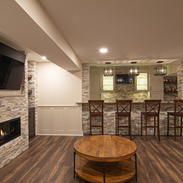 Basement Showing Warm Colors, Straight Lined Cabinets and Stacked Stone