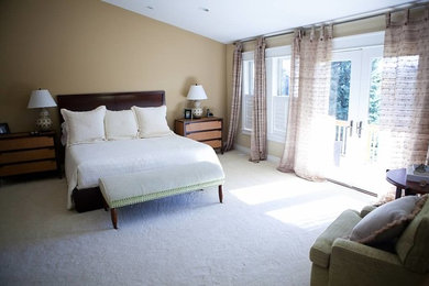 This is an example of a mid-sized traditional master bedroom in Denver with beige walls and carpet.