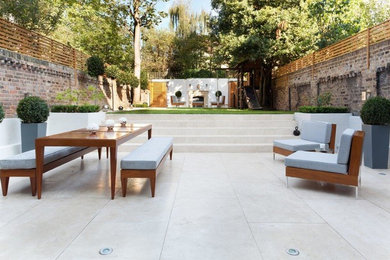 Inspiration for an expansive classic back patio steps in London with tiled flooring and no cover.