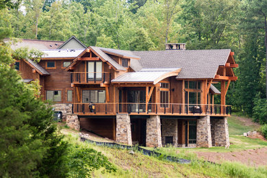 Large modern brown three-story wood exterior home idea in Other