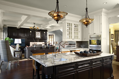 Design ideas for an expansive traditional open plan kitchen in Minneapolis with granite benchtops, black cabinets, stainless steel appliances, dark hardwood floors and with island.