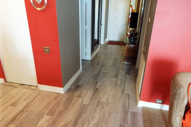 Mid-sized elegant porcelain tile and beige floor hallway photo in Miami with red walls
