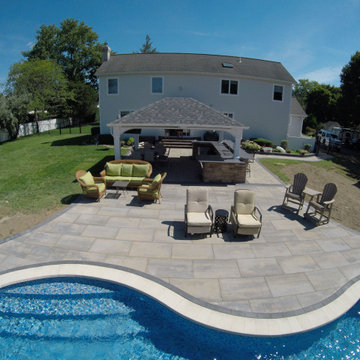 Unilock XL smooth Almond Grove Pool Patio with Travertine Waterfalls - Deer Park
