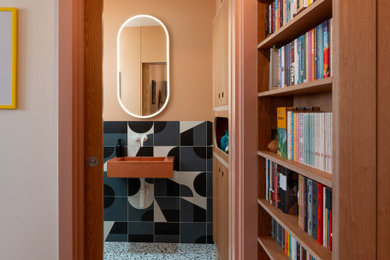 Photo of a small eclectic cloakroom in London with a feature wall.