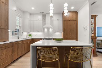 Example of a mid-sized trendy l-shaped vinyl floor eat-in kitchen design in Charleston with shaker cabinets, medium tone wood cabinets, granite countertops, white backsplash, granite backsplash, white appliances, an island and white countertops