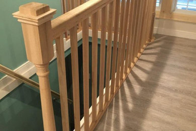 Mid-sized elegant wooden straight wood railing staircase photo in Grand Rapids with wooden risers