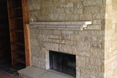 Elegant family room photo in Austin with a standard fireplace and a stone fireplace