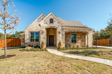 Example of a tuscan two-story mixed siding exterior home design in Dallas