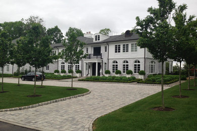 This is an example of a large traditional front yard stone driveway in New York.