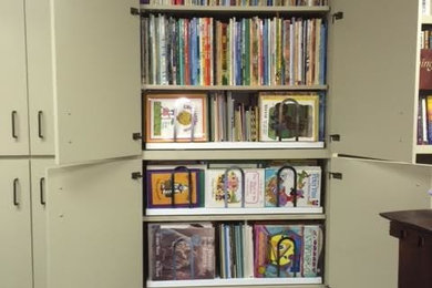 Example of a mid-sized classic gender-neutral carpeted closet design in Dallas with flat-panel cabinets and white cabinets