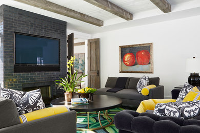Design ideas for a mid-sized contemporary open concept family room in Minneapolis with white walls, dark hardwood floors, a standard fireplace, a tile fireplace surround and a wall-mounted tv.