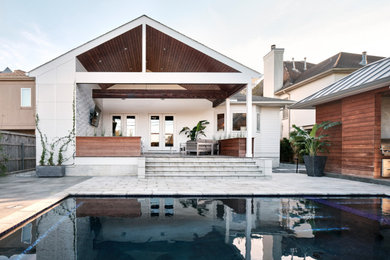 Mid-sized minimalist backyard concrete paver and rectangular lap hot tub photo in New Orleans