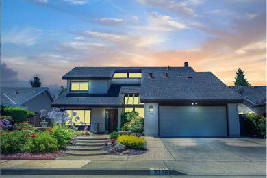 Mid-sized traditional beige two-story stucco house exterior idea in San Francisco with a hip roof and a shingle roof