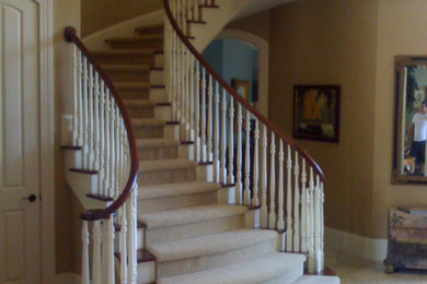 Staircase - traditional carpeted curved wood railing staircase idea in Chicago with wooden risers