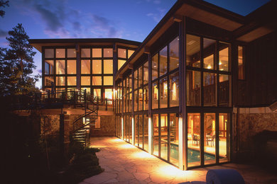 Large trendy two-story glass exterior home photo in Denver