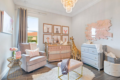 Inspiration for a mid-sized modern girl ceramic tile and gray floor nursery remodel in Miami with gray walls