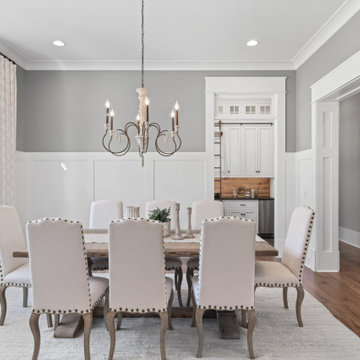 Transitional Dining & Living Room with Vaulted Beams and Stone Fireplace