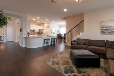 Inspiration for a mid-sized country open concept medium tone wood floor and brown floor family room remodel in Austin with white walls and a corner fireplace