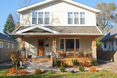 Example of a large classic beige two-story wood gable roof design in Toronto