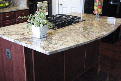 Eat-in kitchen - large transitional dark wood floor eat-in kitchen idea in DC Metro with an island, a double-bowl sink, raised-panel cabinets, red cabinets, granite countertops, beige backsplash and black appliances
