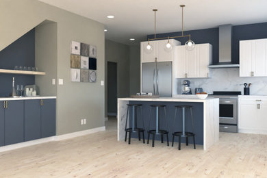 Eat-in kitchen - mid-sized contemporary l-shaped eat-in kitchen idea in Denver with raised-panel cabinets, white cabinets, marble countertops, white backsplash, marble backsplash, an island and white countertops