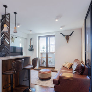 Esempio di un piccolo soggiorno design aperto con angolo bar, pareti bianche, pavimento in legno massello medio, TV a parete e pavimento marrone