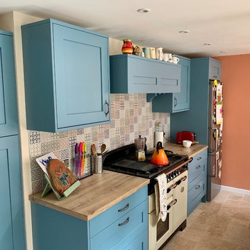 Fun family kitchen. Blue Painted shaker kitchen with imitation wood worksurface