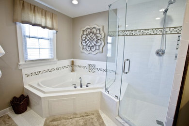 Mid-sized elegant master multicolored tile and white tile porcelain tile and white floor bathroom photo in Richmond with recessed-panel cabinets, dark wood cabinets, beige walls, an undermount sink, marble countertops, a hinged shower door and gray countertops
