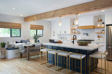 Eat-in kitchen - mid-sized transitional galley light wood floor and beige floor eat-in kitchen idea in San Diego with a farmhouse sink, shaker cabinets, white cabinets, white backsplash, stainless steel appliances, an island, white countertops, quartz countertops and mosaic tile backsplash