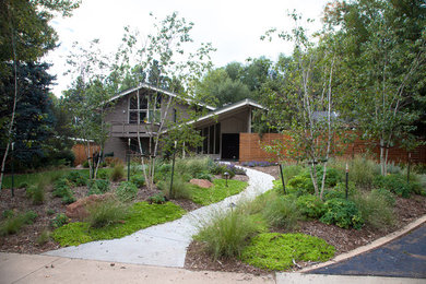 Photo of a mid-sized contemporary drought-tolerant and partial sun front yard concrete paver and wood fence walkway in Denver for summer.