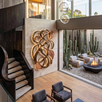Vestíbulo Casa Florentino — Escultura y luz bajo doble altura