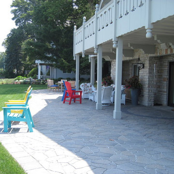 A wide walkway connects the two patios
