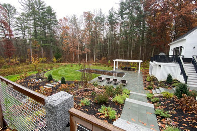 Photo of a mid-sized contemporary backyard wood fence landscaping in Boston.