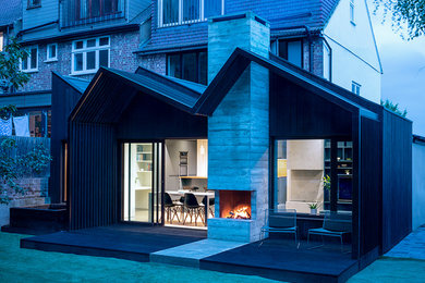 Photo of a medium sized modern galley kitchen/diner in London with flat-panel cabinets, blue cabinets, engineered stone countertops, concrete flooring and an island.