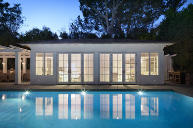 Inspiration for a small timeless white one-story house exterior remodel in Los Angeles with a hip roof