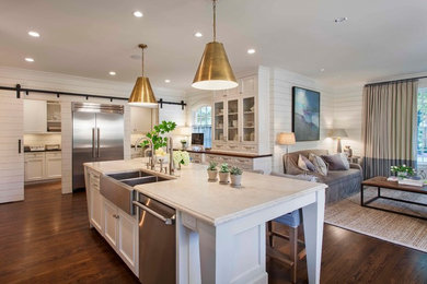 Transitional medium tone wood floor kitchen photo in Charlotte with a double-bowl sink, recessed-panel cabinets, white cabinets, marble countertops, stainless steel appliances and an island