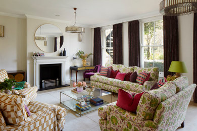 Large eclectic enclosed ceramic tile and beige floor living room photo in London with a standard fireplace