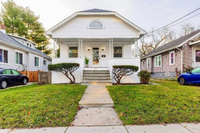 Large traditional white one-story vinyl house exterior idea with a shingle roof and a black roof