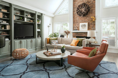 Example of a large trendy open concept medium tone wood floor, gray floor and vaulted ceiling living room design in Atlanta with white walls, a standard fireplace, a stone fireplace and a media wall