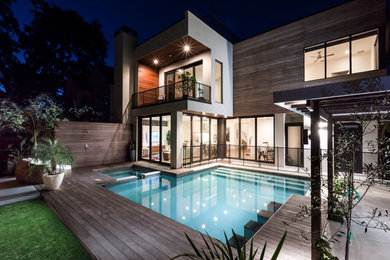 Inspiration for a large modern three-storey white exterior in Austin with wood siding and a flat roof.