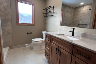 Example of a mid-sized porcelain tile porcelain tile and single-sink alcove shower design in Chicago with a two-piece toilet, solid surface countertops and a built-in vanity