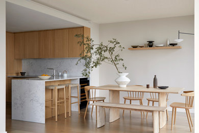 Small scandi dining room in London with beige walls and light hardwood flooring.